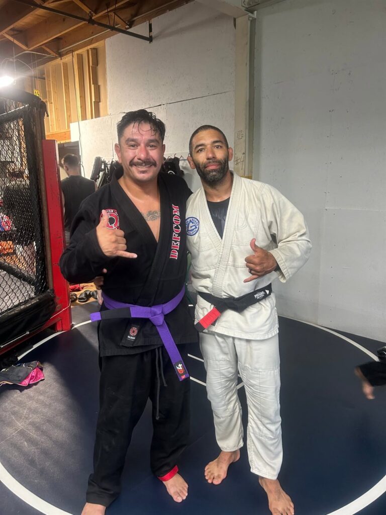 Two Brazilian Jiu-Jitsu students shaking hands after rolling at J's Kickboxing Club